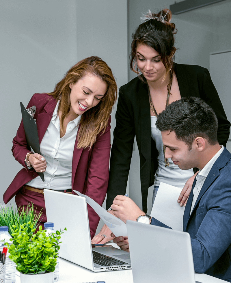 a group of people looking at papers